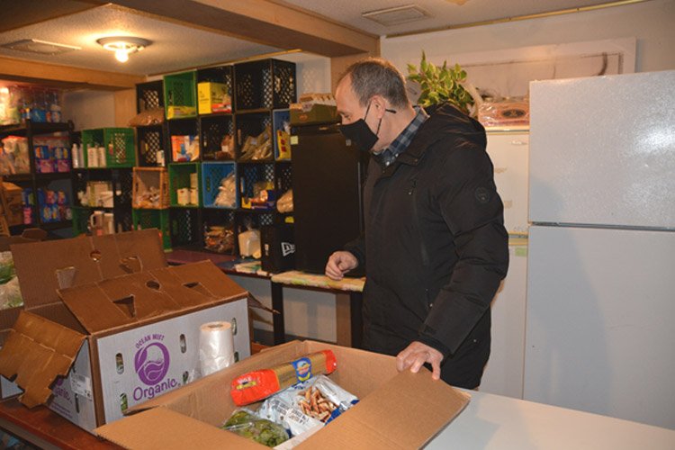 Bob Charendoff putting together meal boxes in the Seeds of Hope Pantry